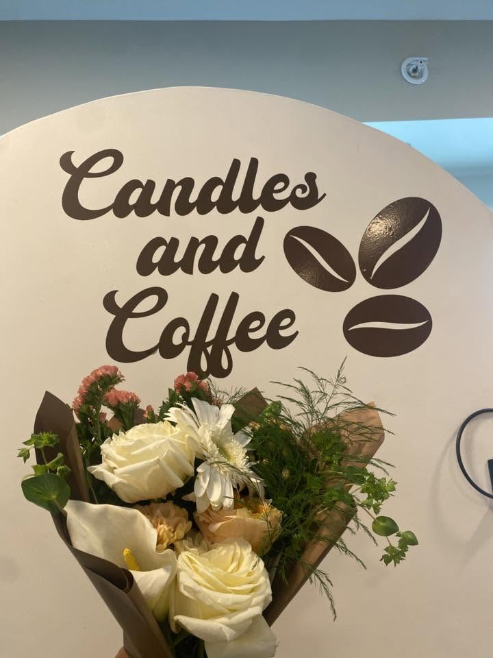 Bouquet in front of the Candles and Coffee sign
